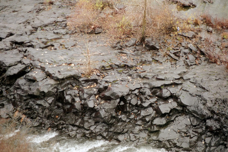 [Wet black rock as if it was chunked together and then partially remelted into one piece.]